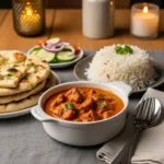 Butter chicken served with naan bread and steamed rice—complete homemade Indian meal for family dinner