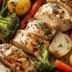 Sheet pan meal featuring garlic butter chicken and assorted veggies