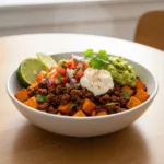 Sweet potato taco bowl with ground beef, pico de gallo, guacamole, and sour cream—healthy, gluten-free dinner recipe