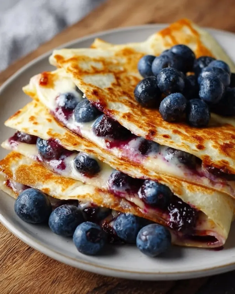 Blueberry breakfast quesadilla with melted cheese and fresh blueberries