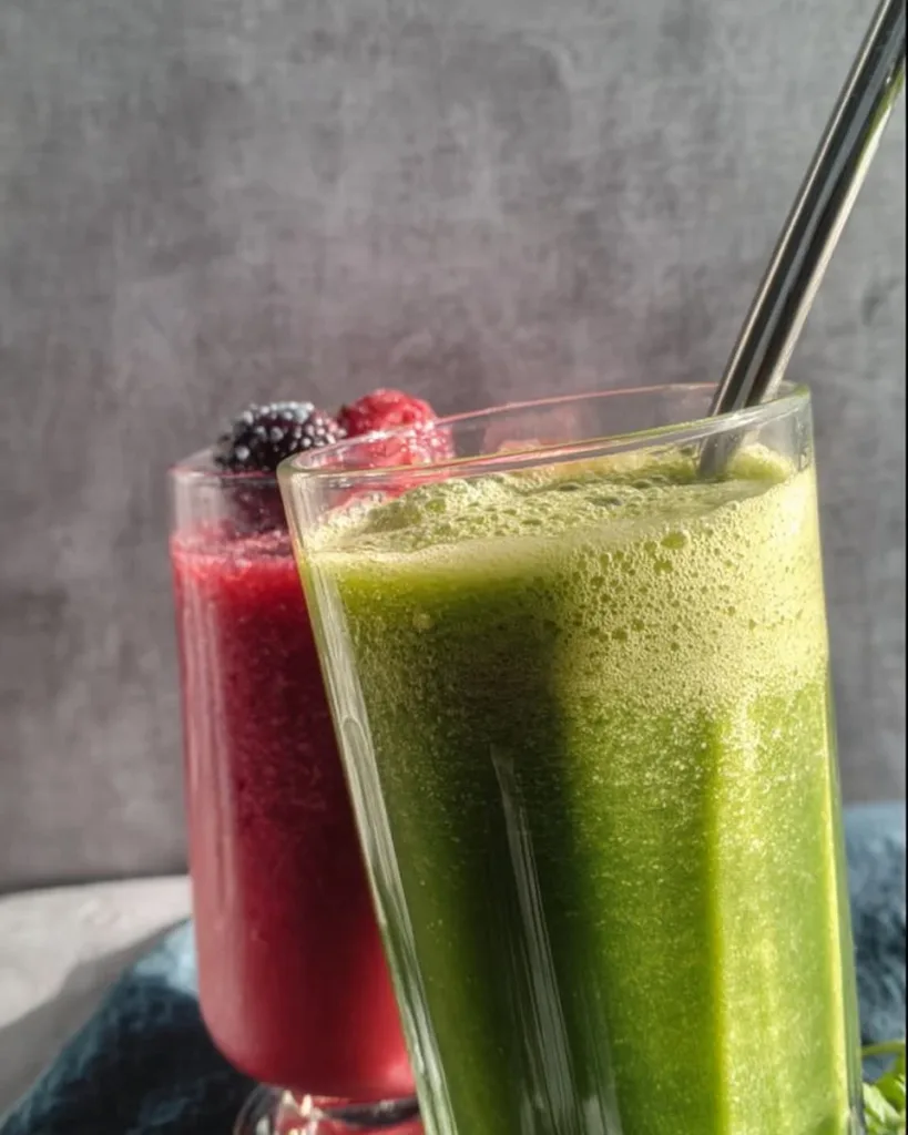Strawberry-Banana Green Smoothie in a glass garnished with fresh fruits